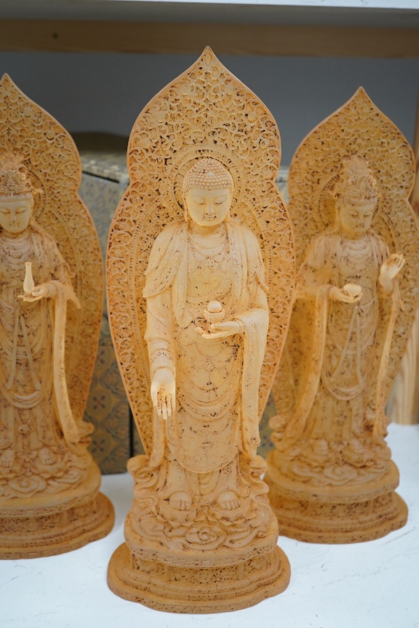 A set of three large Chinese glass figures of Bodhisattva, rust finish, with cases, 42cm high. Condition - good